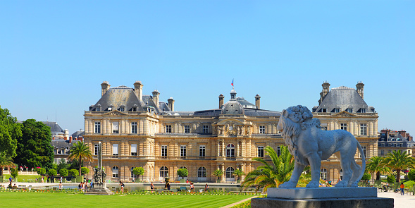 Paris, France - June, 2018: Luxembourg gardens and palace in Paris, France, panoramic view. Lion sculpture
