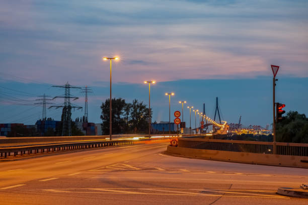 Street to the Köhlbrand Bridge Way to the Köhlbrandbrücke with street lights at night long exposure industry factory hamburg germany stock pictures, royalty-free photos & images