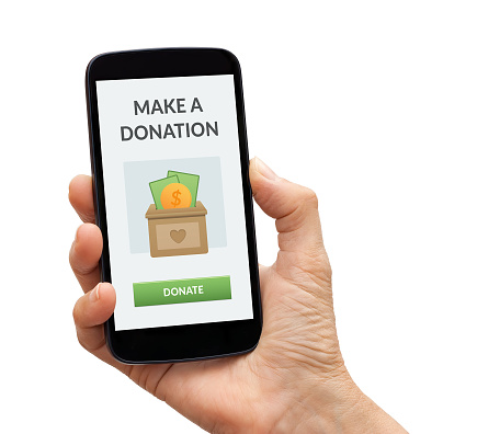 Hand holding a black smart phone with donate concept on screen. Isolated on white background.