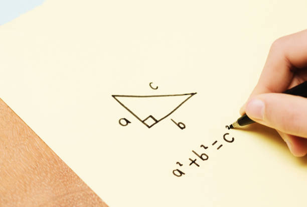 Child does her math homework, pen in hand Little girl doing mathematics on a piece of paper. pythagoras stock pictures, royalty-free photos & images