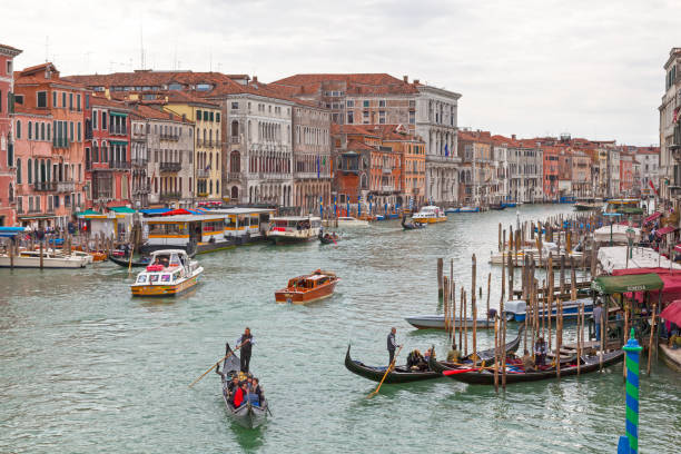 Gondolier on the Grand Canal of Venice Venice, Italy - April 06 2019: Grand Canal with the Palazzo Loredan (Municipal administration office), the Ca' Farsetti (City hall) the Palazzo Cavalli (Government office) and the Palazzo Grimani di San Luca (Court of Appeal). venize stock pictures, royalty-free photos & images