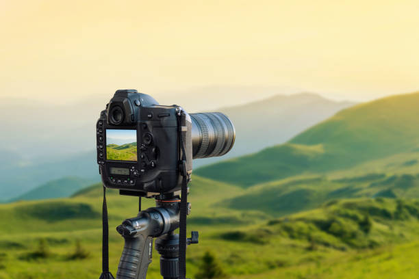 istock Modern camera on tripod photographs the landscape. 1182274542