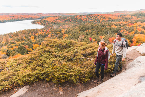 istock Couple hiking, autumn scene, colourful trees on background 1182276280
