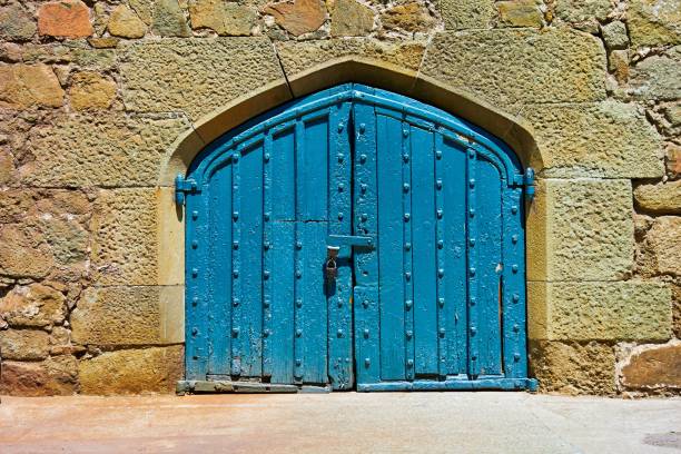 ancient stone wall for vintage background with old wooden gate closeup
