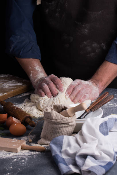 istock Baker prepares the dough on table. Homemade pastry. 1182277859