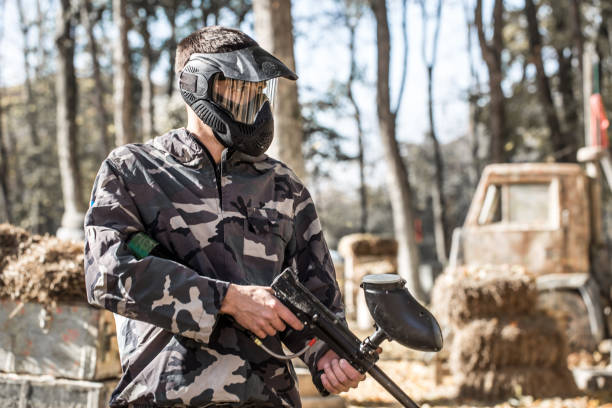 istock A man with a gun playing paintball. 1182280159