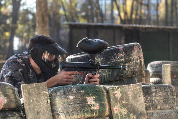 istock A man with a gun playing paintball. 1182280162