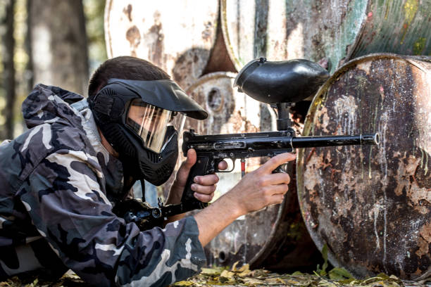 istock A man with a gun playing paintball. 1182280179