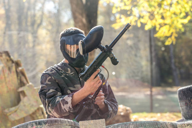 istock A man with a gun playing paintball. 1182280182