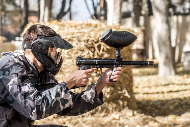 istock A man with a gun playing paintball. 1182280183