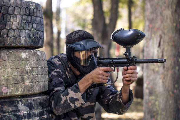 istock A man with a gun playing paintball. 1182280198