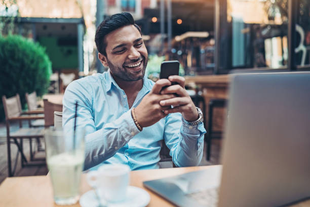 istock Smiling businessman using a cell phone 1182280263