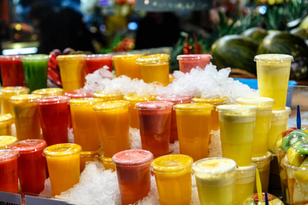 istock Fresh juice from fruits and vegetables in plastic cups covered with ice 1182282877