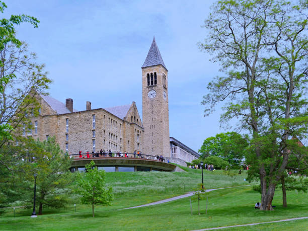 Cornell University campus on graduation day. Ithaca, NY, USA - May 26, 2019: Graduating students and their families talk to friends and take photos on the Cornell University campus after graduation ceremonies. cornell university stock pictures, royalty-free photos & images