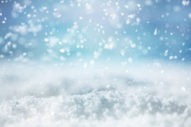 istock Christmas winter background with snow and blurred bokeh 1182284978