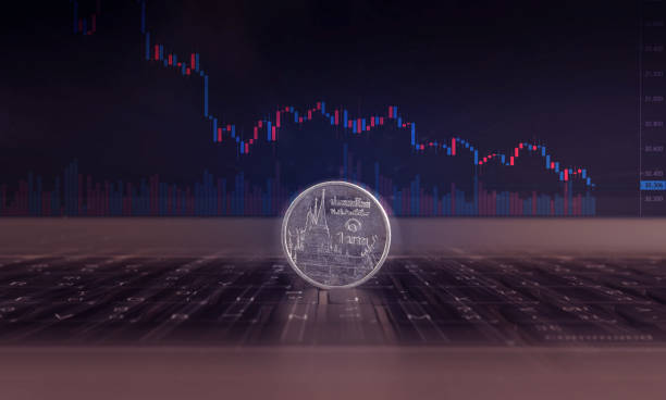 istock close up 1 baht Thai coin placed on a laptop keyboard 1182285310
