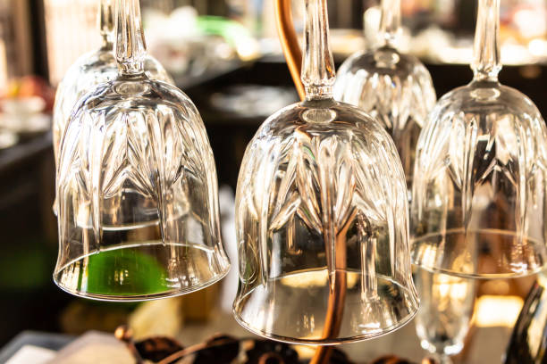 istock transparent cup with a thin leg hanging above the bar, selective focus 1182286589
