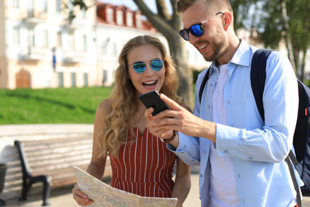 istock Lovely couple on vacation are looking at map for direction 1182286605