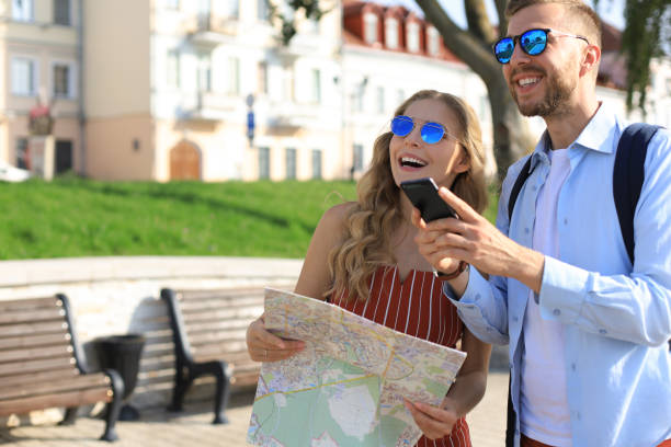 istock Lovely couple on vacation are looking at map for direction 1182286630