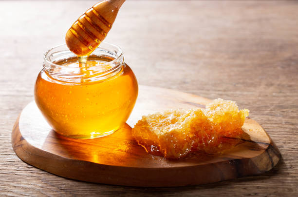 istock jar of honey with honeycombs 1182286745