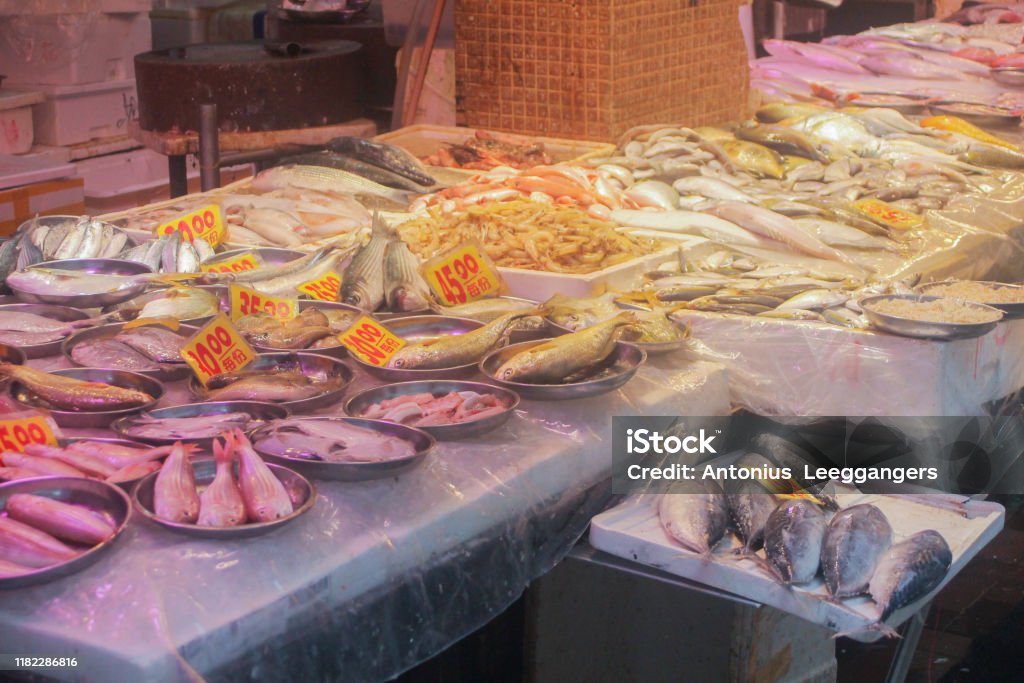 Chinees food market HONG KONG vegetables, fish and fruit Chinees food market HONG KONG vegetables, fish and fruit. Green, orange, yellow and red colors. Central District - Hong Kong Stock Photo