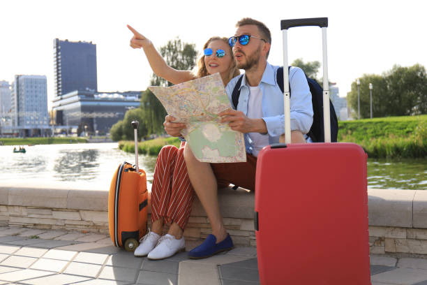 istock Lovely couple on vacation are looking at map for direction 1182286860