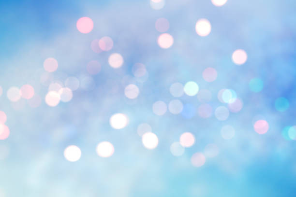 Abstract blurred soft blue and white beautiful glowing blinking bokeh and snowfall on colorful background for merry christmas and happy new year design banner and presentation concept