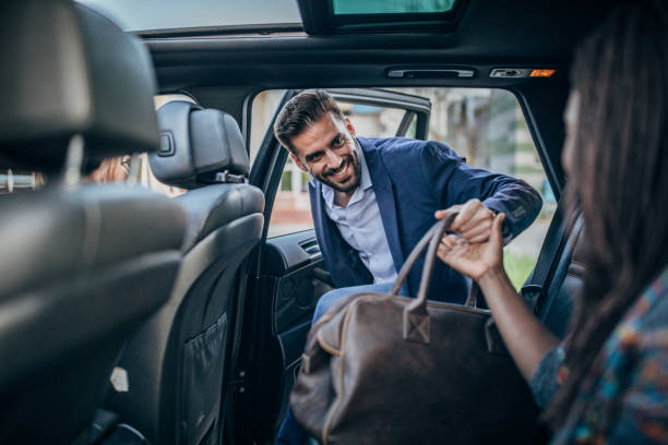 istock Man in suit entering a car 1182287249