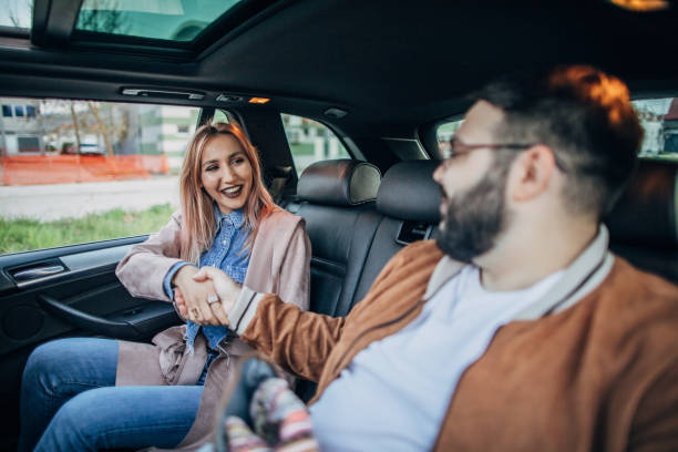 istock Friends handshaking in a car 1182287749