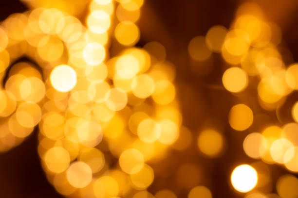 istock blurry beautiful golden spots, bright and festive abstract background design 1182288636