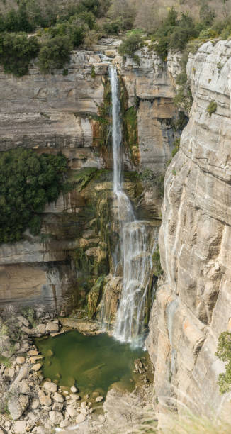 istock High water jump with cliff fall in mountainous area. 1182288768