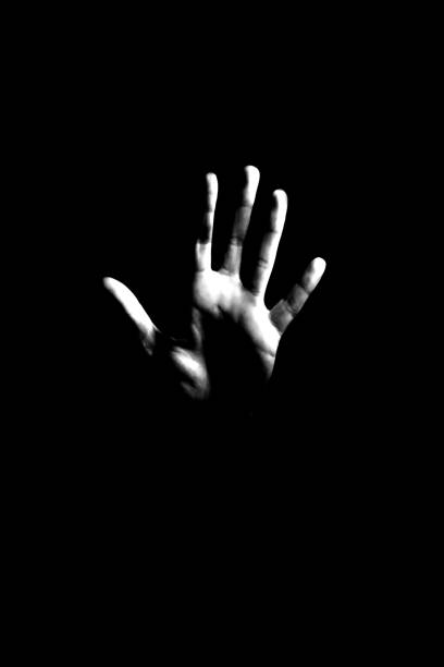 Spooky background. Hand in a dark. stock photo