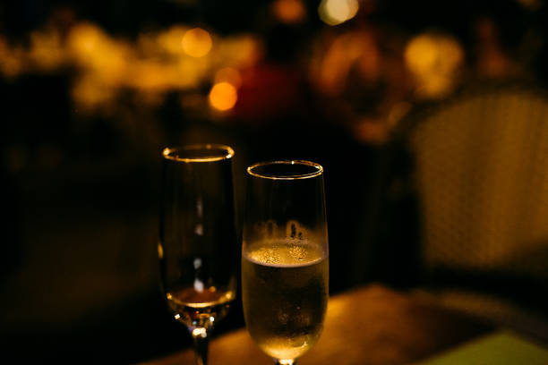 istock two glasses champagne holiday background with garlands 1182289831