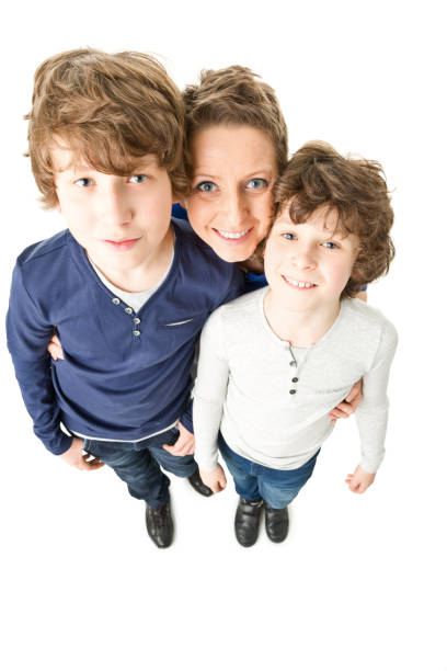 Portrait of a mother bonding with her two little children outdoors