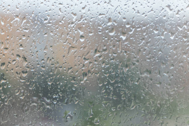 istock Raindrops on the window glass with blurred background. 1182293546