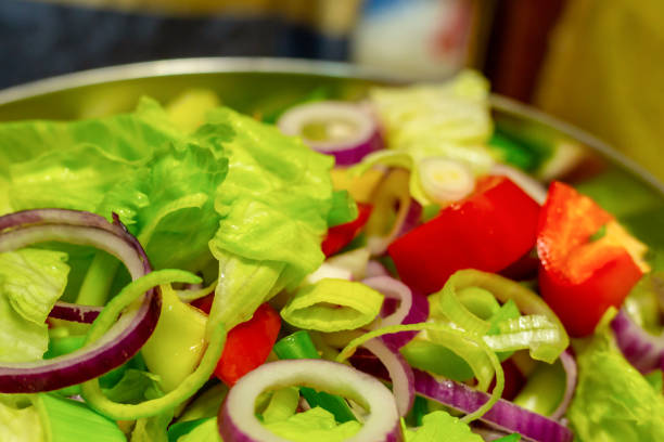 fresh delicious salad decorated with red onion ring close-up culinary background