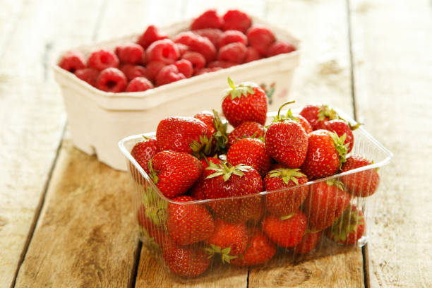 istock Boxes with strawberries and raspberries 1182297290