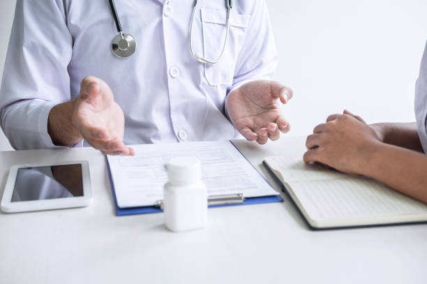 istock Doctor consulting with patient and checking sickness condition while presenting results diagnosis symptom examining about the problem of illness and recommend treatment method, Healthcare and medical 1182297619