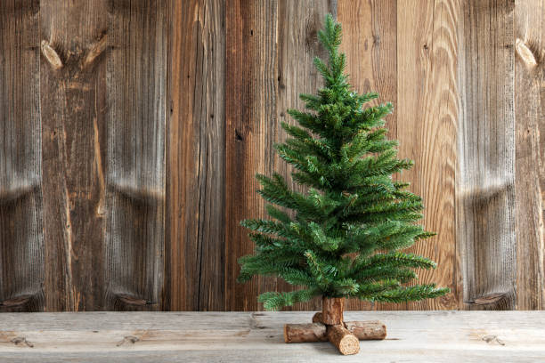 istock One Christmas Tree, Brown Wooden Background Or Texture 1182299540