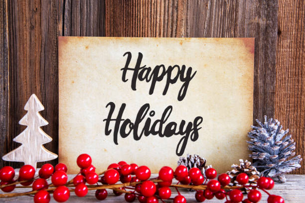 Paper With English Text Happy Holidays. Christmas Decoration And Wooden Background