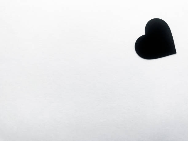 istock Black heart in the upper right corner of the frame on a white background 1182300021