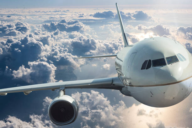 istock Front view of an Airplane Flying Through Clouds 1182301076