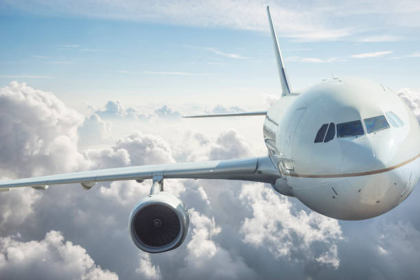 istock Front view of an Airplane Flying Through Clouds 1182301295