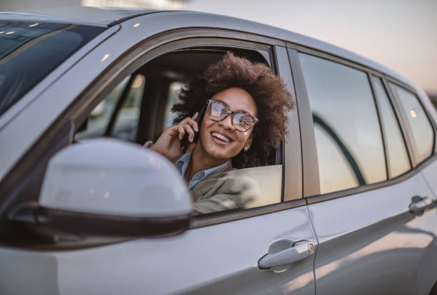 istock Business woman using smart phone in a car 1182301783