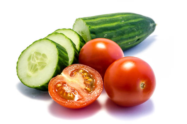 istock green cucumber and tomato isolated on white background 1182303456