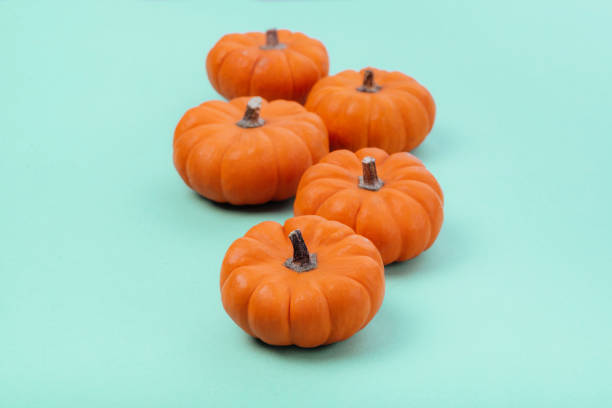 istock Pumpkins over neo mint background. 1182303726