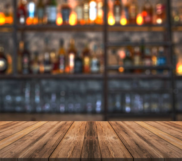 Bar With Blurred Lights Bokeh And Wooden Table Bar With Blurred Lights  Bokeh And Wooden Table Stock Photo - Download Image Now - iStock