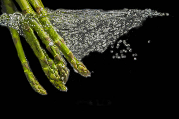 istock the asparagus in the water. 1182305134