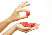 Female hands with raspberries