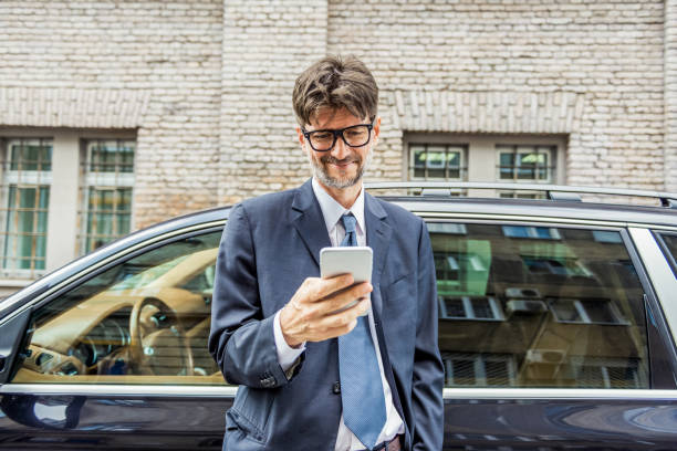 istock handsome businessman using his smartphone in the city 1182308856